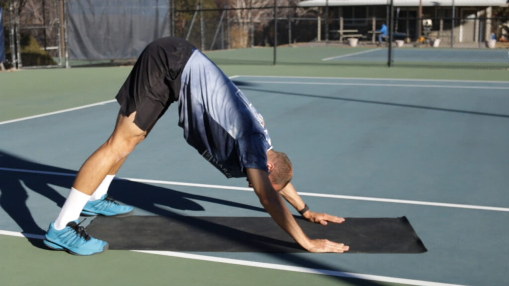 Downward dog stretch tennis post match