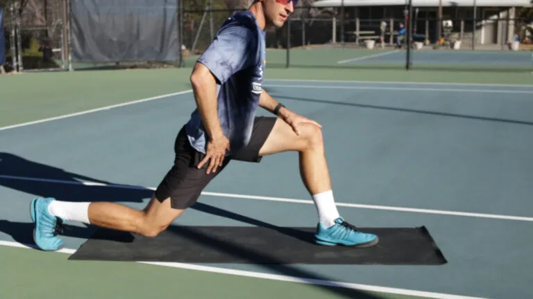 Runner's lunge stretch for tennis players — hip flexor and quad stretch after match