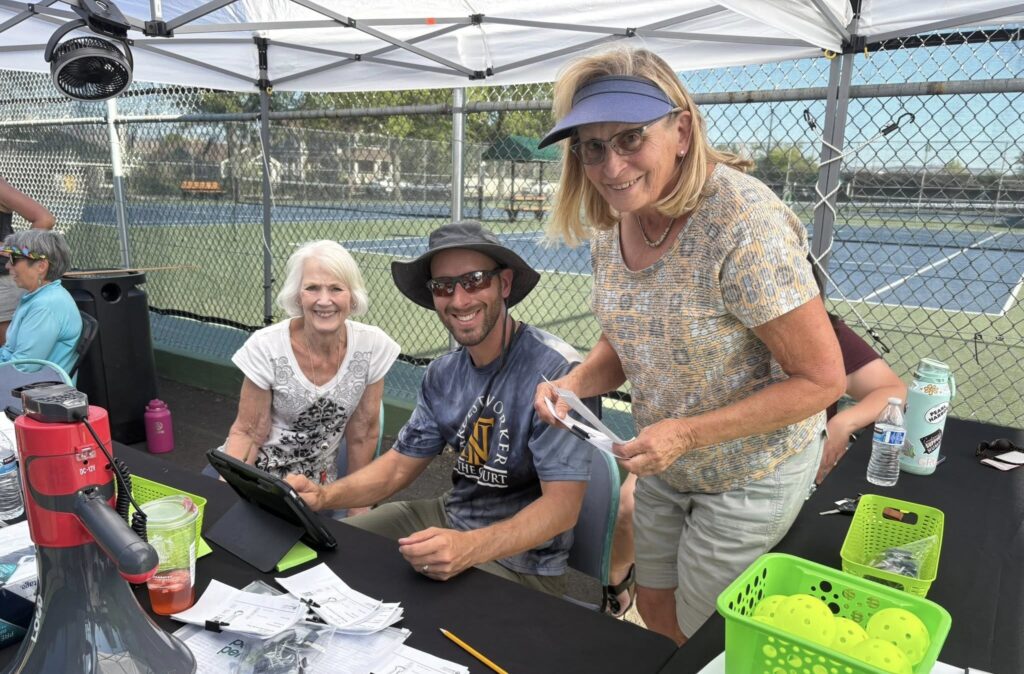 Tennis Nation Racquet Sports staff helping members with questions about membership